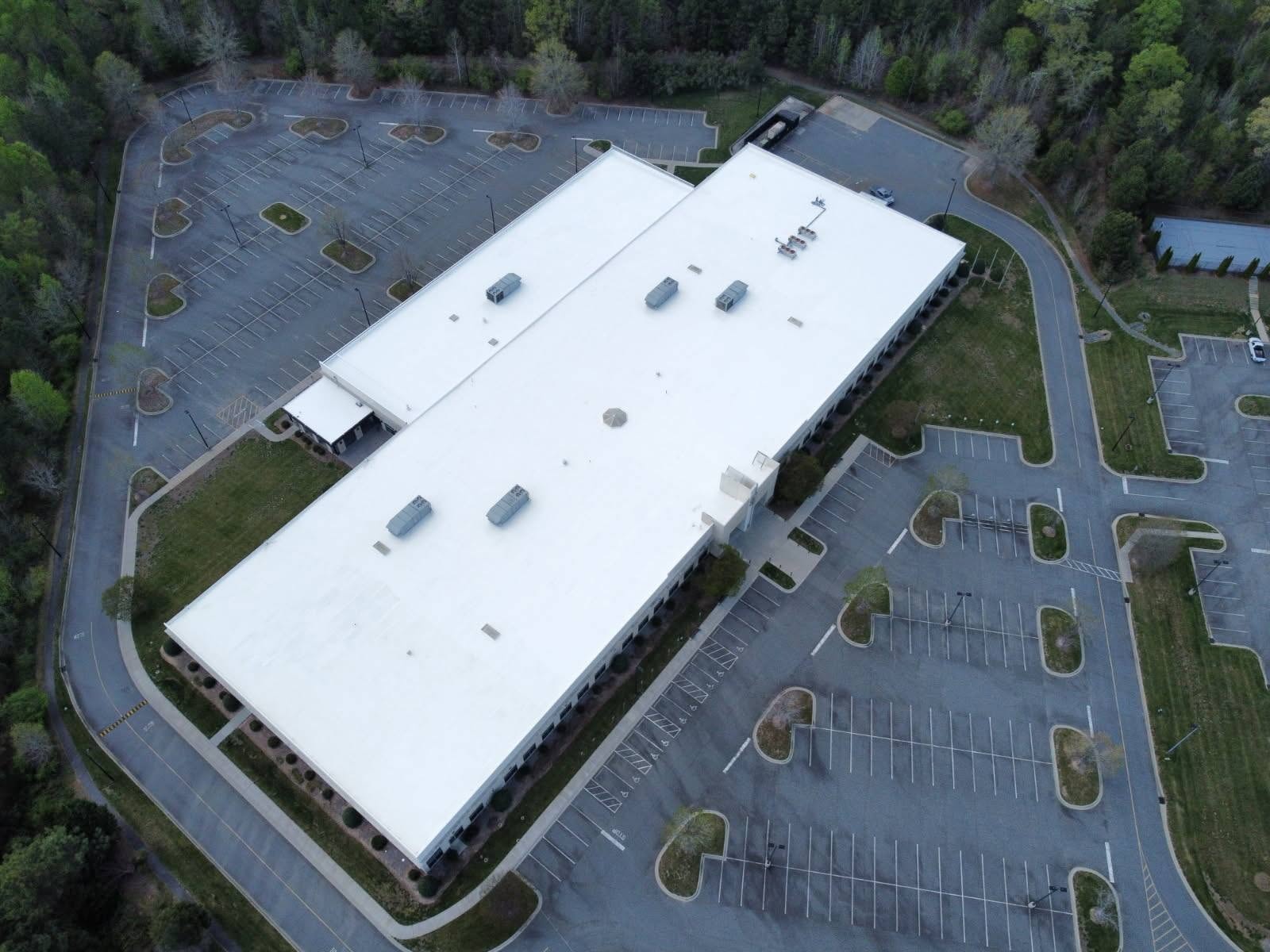 Fort Mill commercial property completed white roof coating — wide aerial