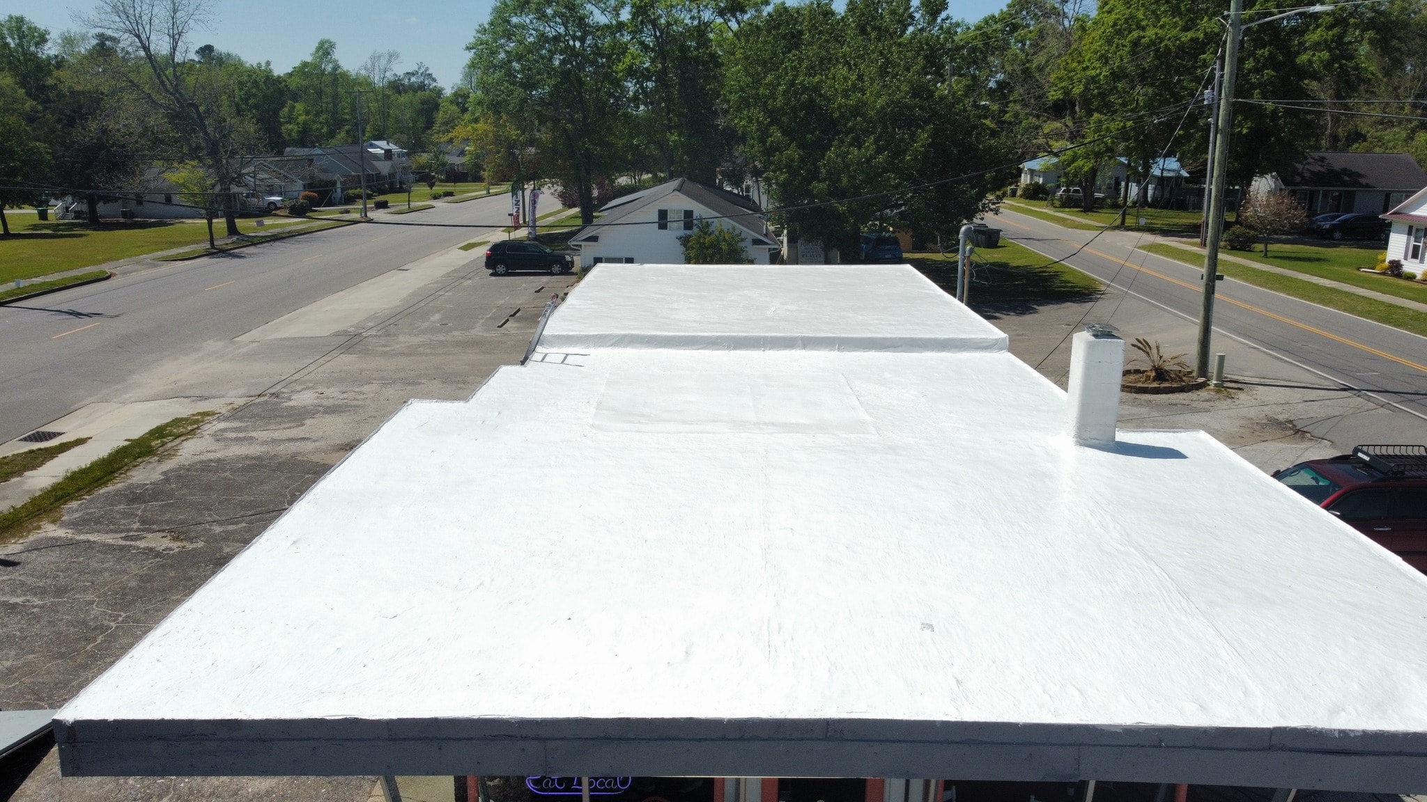 Little River Cafe completed white roof coating — ground level view