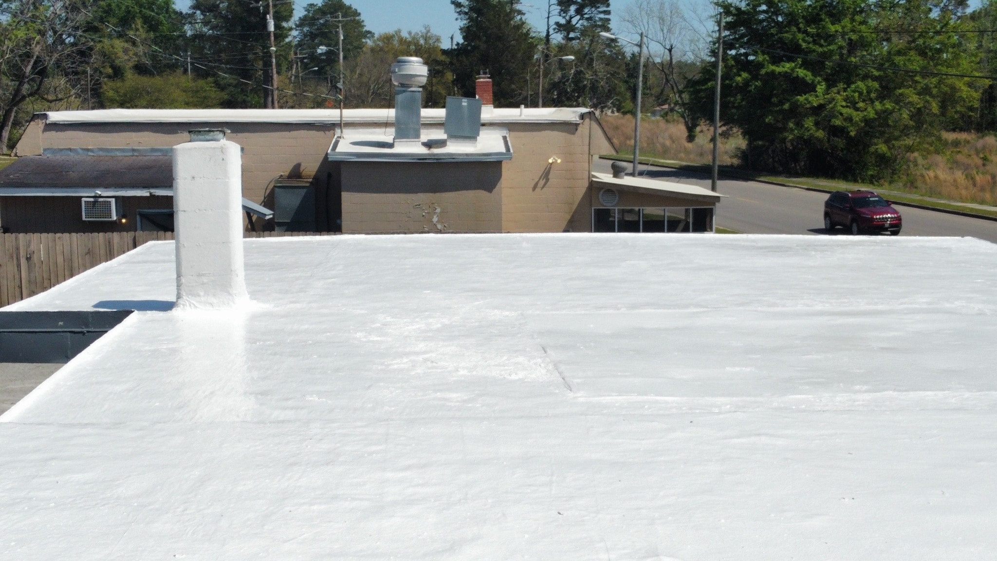 Little River Cafe roof before coating — severely deteriorated surface with peeling and exposed areas