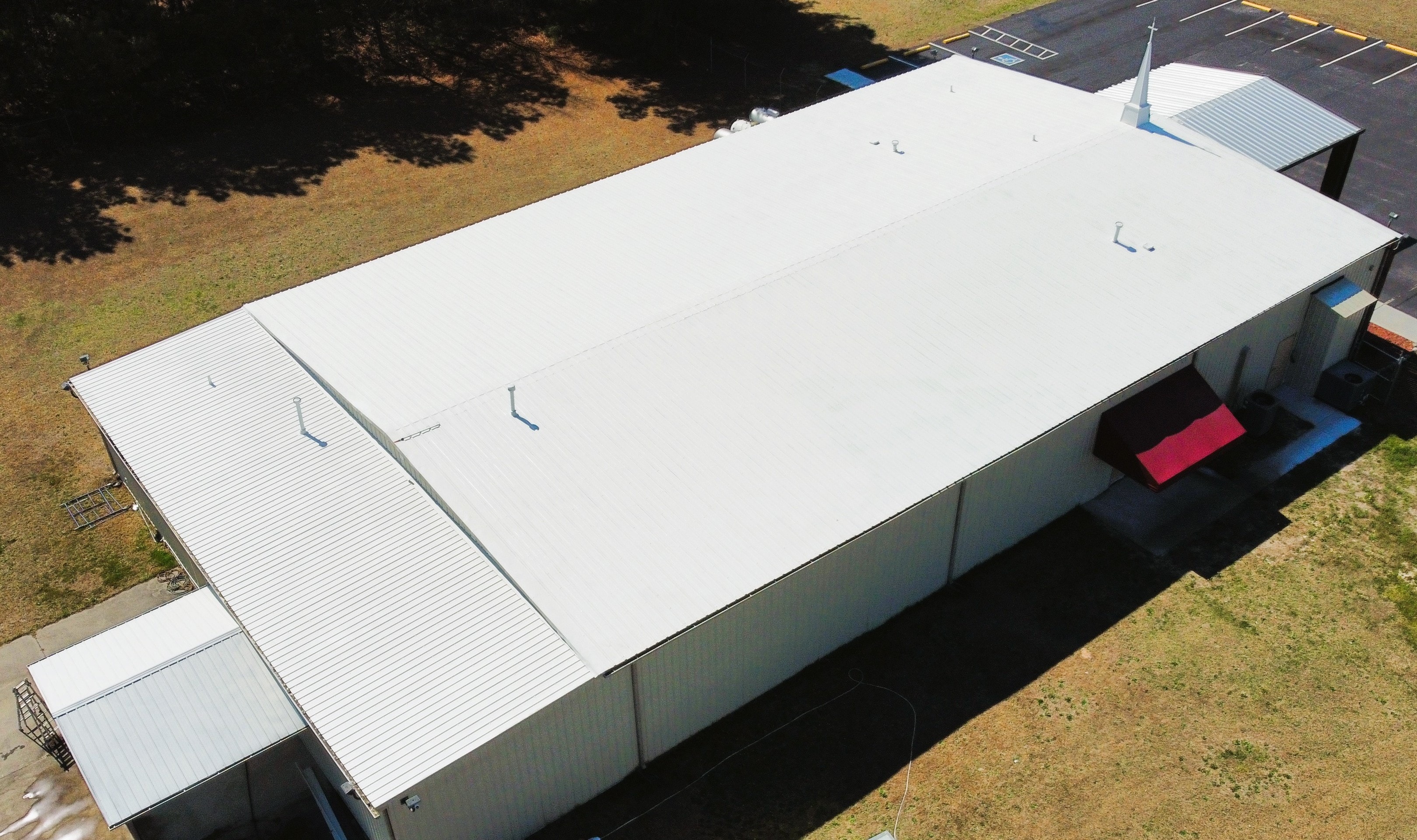 Lumber Bible Church finished roof — Summit trailer on site, aerial view