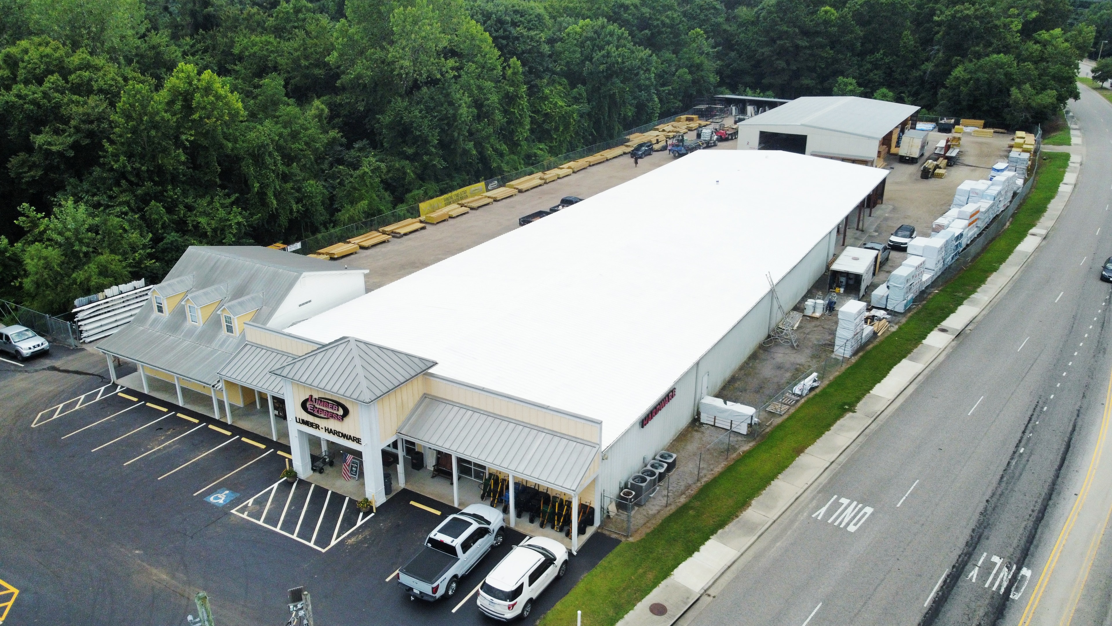 Lumber Express completed white roof coating — wide aerial