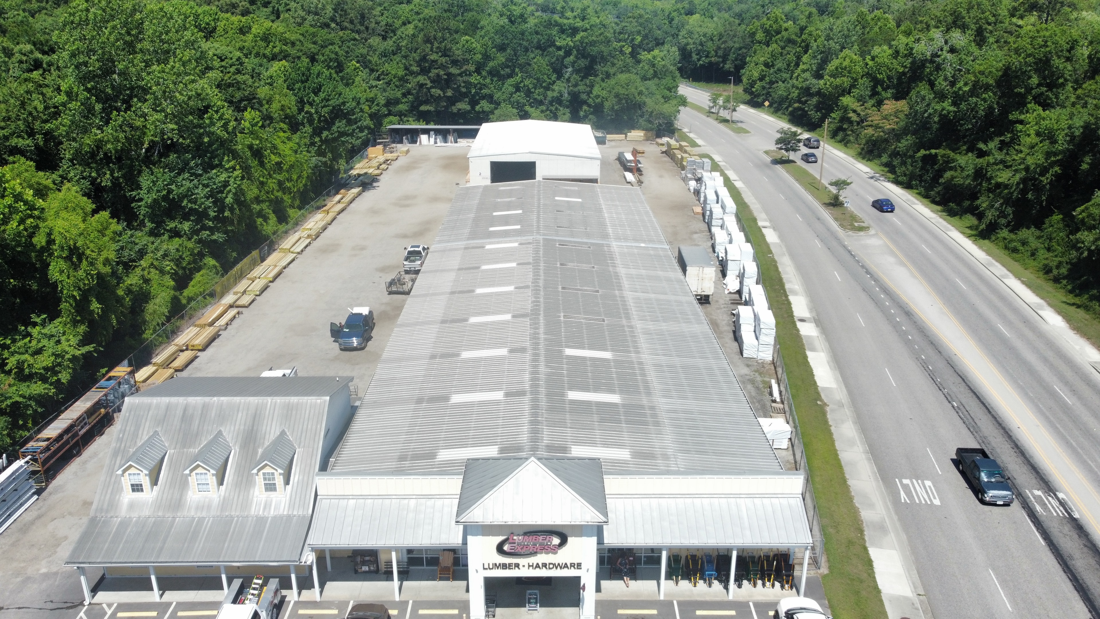 Summit crew applying white roof coating at Lumber Express