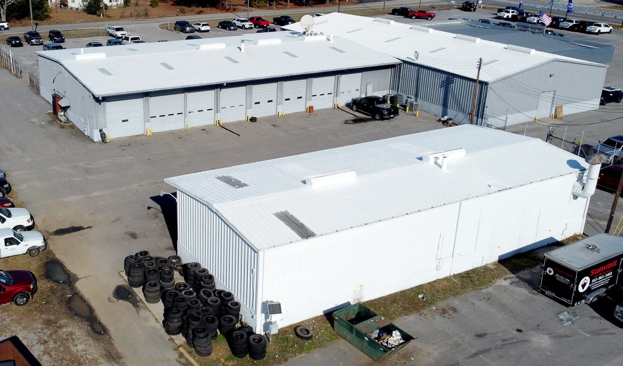 Raceway Chevrolet dealership roof before coating — rusted metal surface aerial view